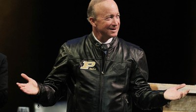 
              Indiana Gov. Mitch Daniels displays his new Purdue leather jacket given to him by the board of trustee after being named as the next president of Purdue University by the school